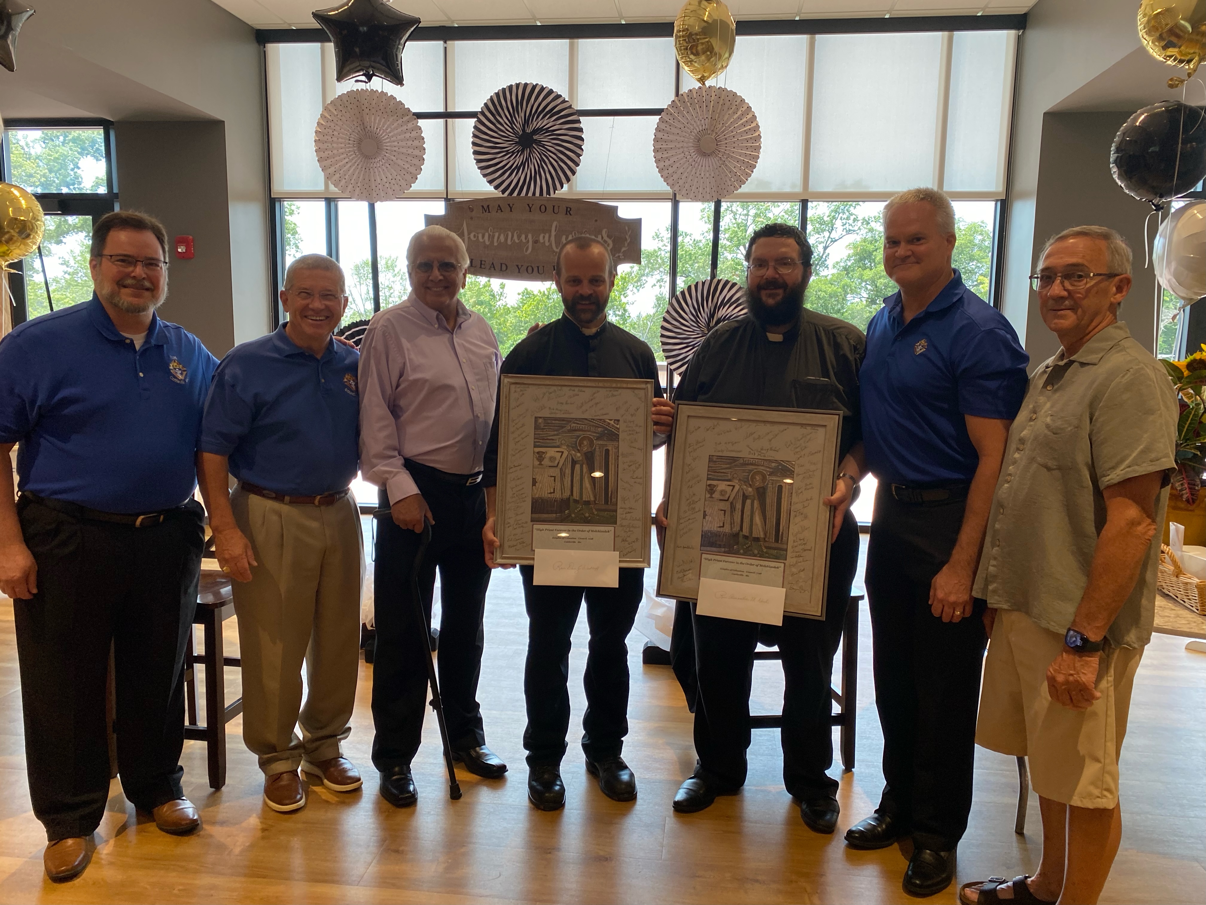 Knights from Fr William Pezold Council 7198 presenting signed pictures of Melchizedek to Fr. Nord and Fr. Westhoff's at their Farewell Reception